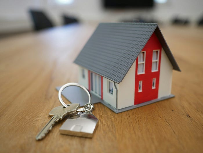 Photo 4. Buying a house, photo by Tierra Mallorca on Unsplash, photo showing a house and a key for it next to it.